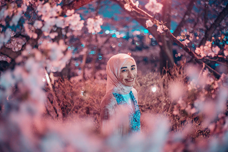Portrait of girl standing on cherry tree