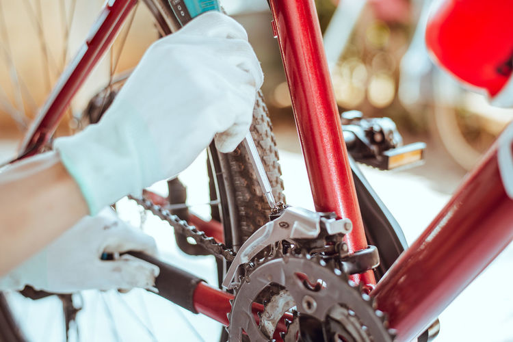 Cropped hands of person repairing bicycle