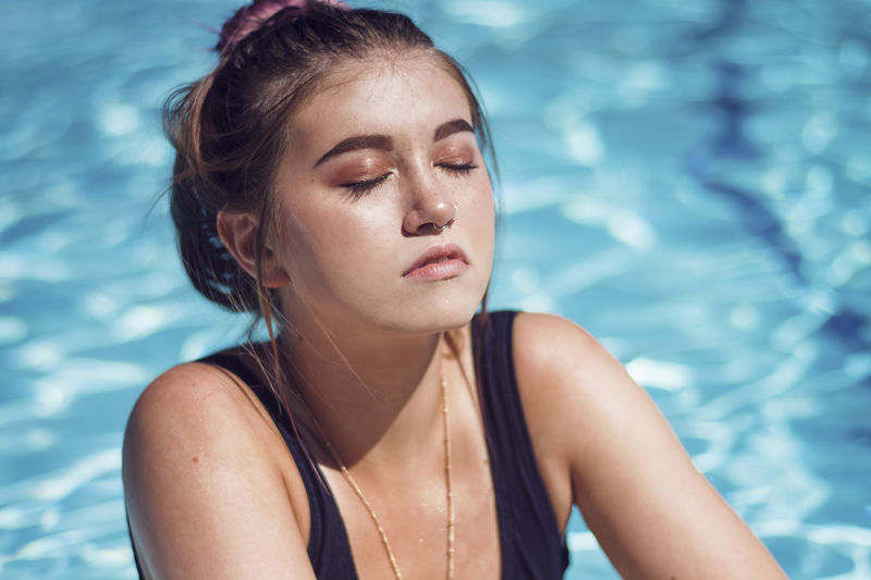 Young woman with eyes closed in swimming pool