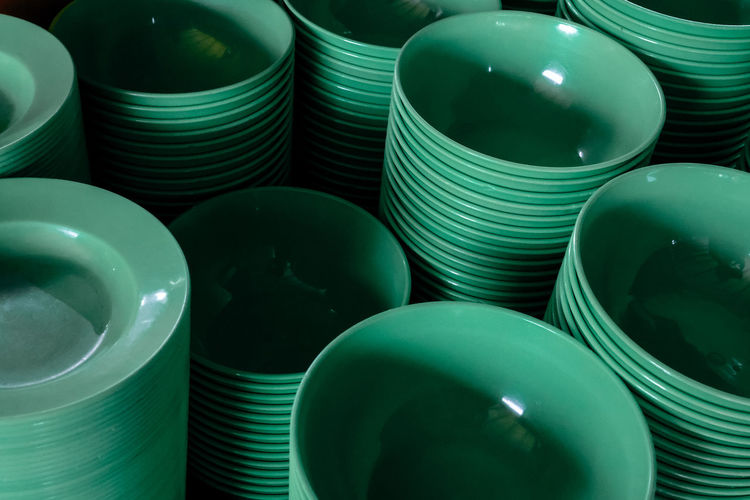 A stack of green plastic bowl