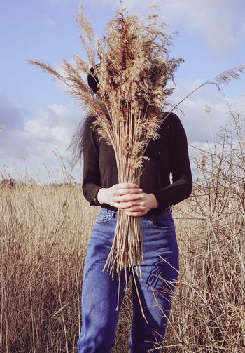 Woman holding a bunch of dried pampas grass. countryside dried pampas.