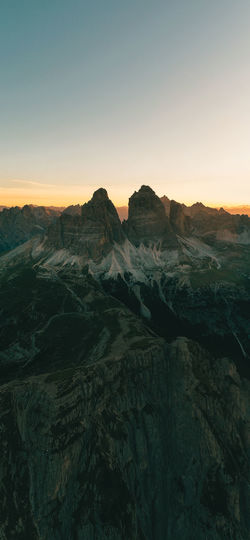 Scenic view of mountains against clear sky during sunset