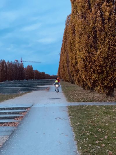 People riding motorcycle on road against sky