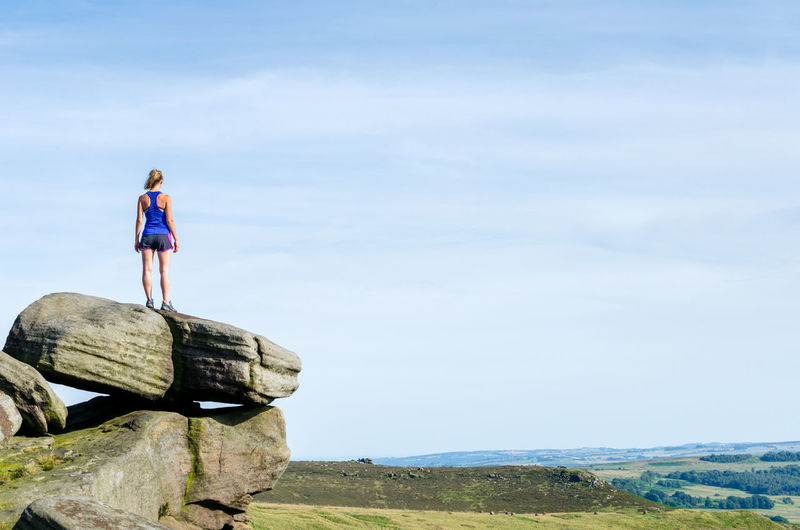 Active woman at stanage in the peak district, derbyshire, england