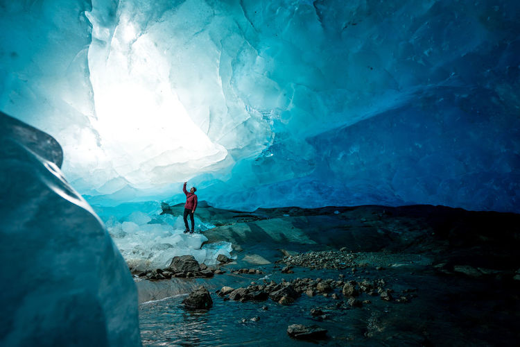 Full length of man standing in ice cave