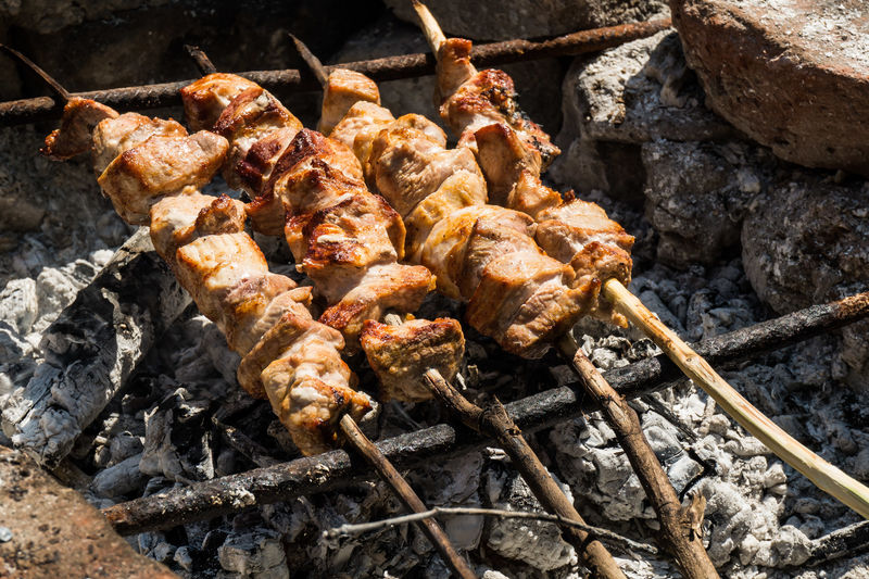High angle view of meat skewers on barbeque