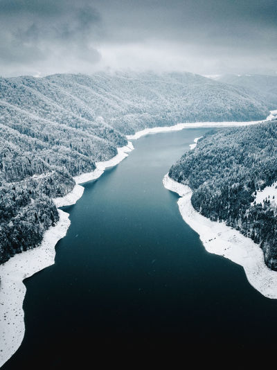 Aerial view of river against sky during winter