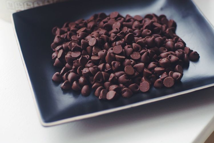 Close-up of chocolate chips in plate on table