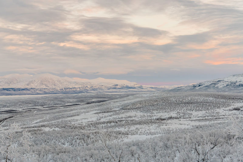 Scenic view of snowcapped mountains against sky during sunset