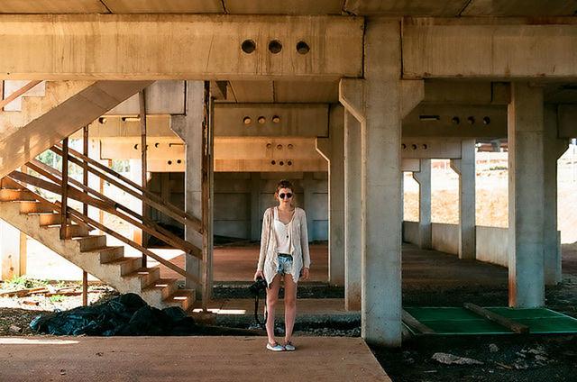Full length portrait of woman standing on bridge