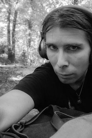 Portrait of young man sitting outdoors
