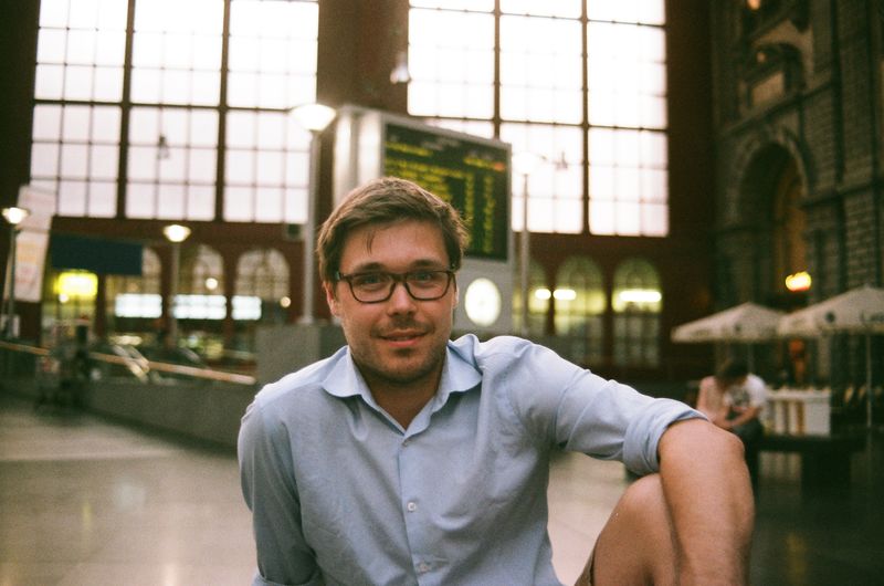 Portrait of man sitting in railway station