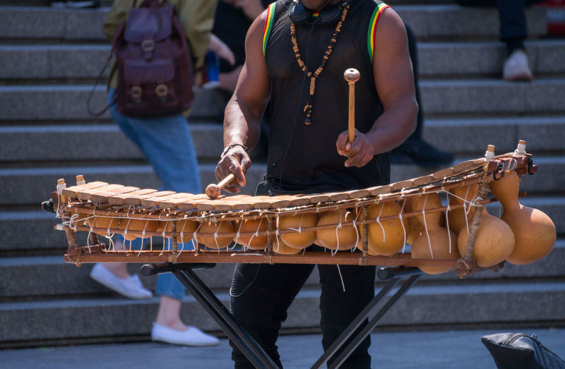 Midsection of musician playing on street