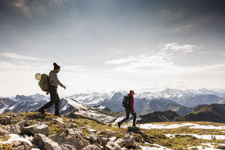 Germany, bavaria, oberstdorf, two hikers walking in alpine scenery