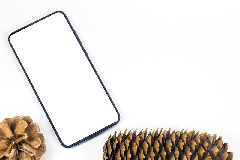 High angle view of smart phone against white background