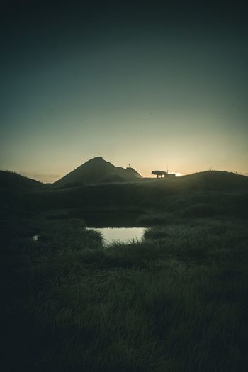 Scenic view of field against sky during sunset