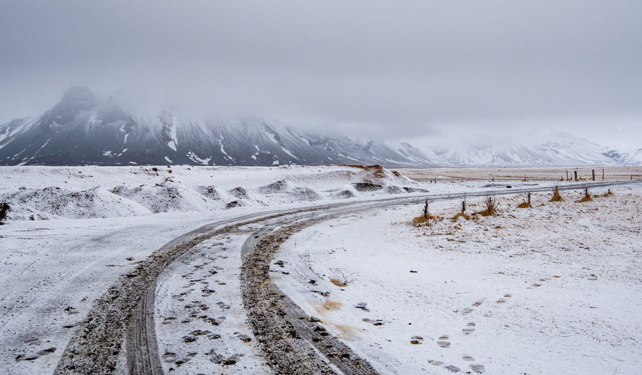 Empty highway countryside frozen road with snow in winter in iceland