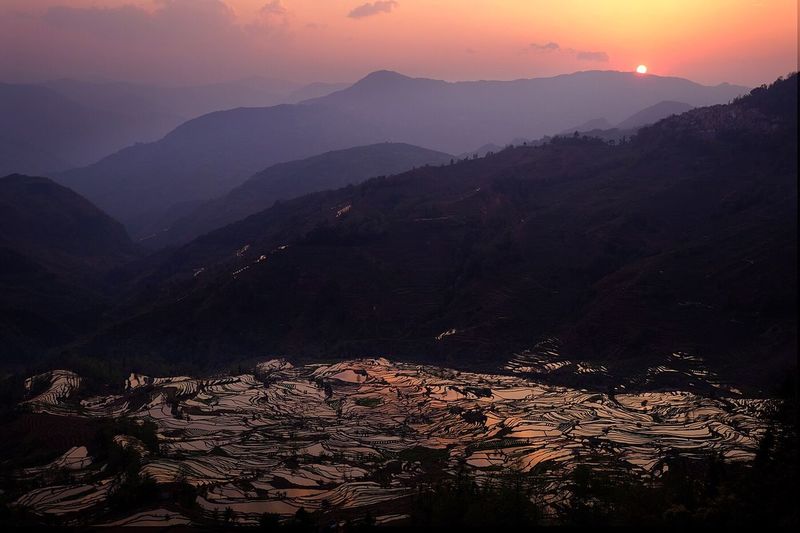 Scenic view of mountains against sky during sunset