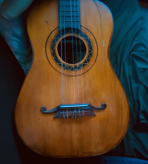 Close-up of guitar against black background