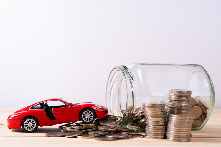Close-up of vintage car on table against white background