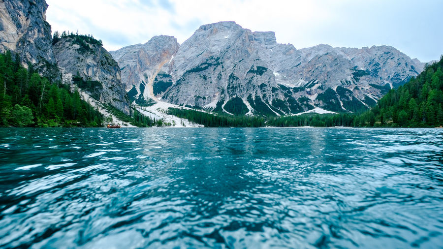 Last hour light with fantastic colors as we paddle our boat at braies lake, italian dolomites
