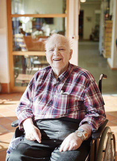 Smiling senior man on wheelchair