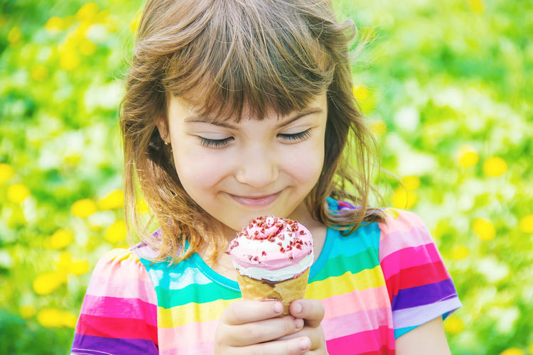 Portrait of girl blowing ice cream cone