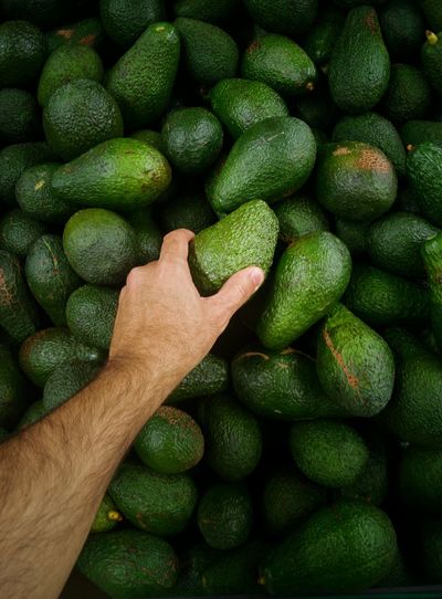 High angle view of green avocado for sale in market