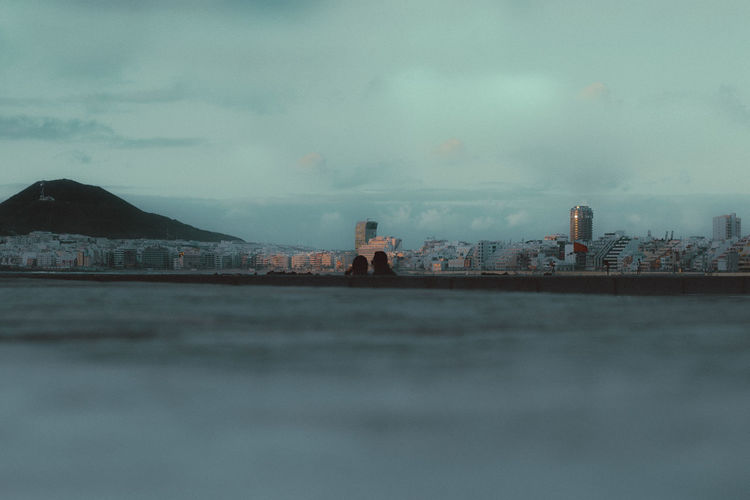 Surface level of buildings against cloudy sky during sunset