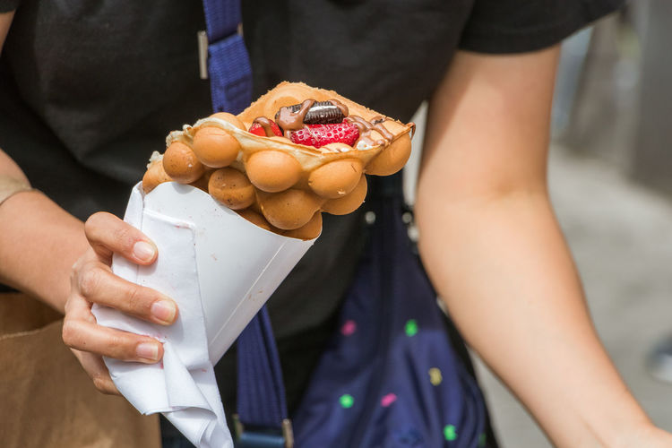 Midsection of woman holding ice cream