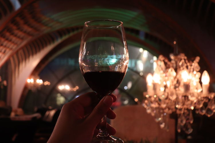 Hand raising a glass of wine