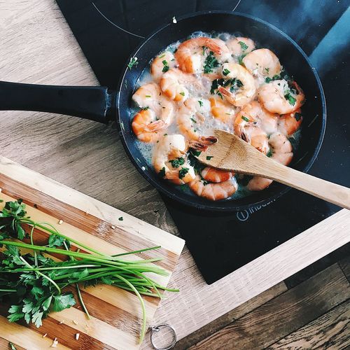 Directly above shot of shrimp in cooking pan on induction