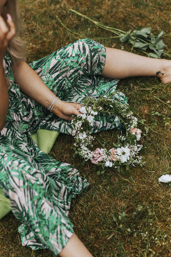 Midsection of woman sitting on grass