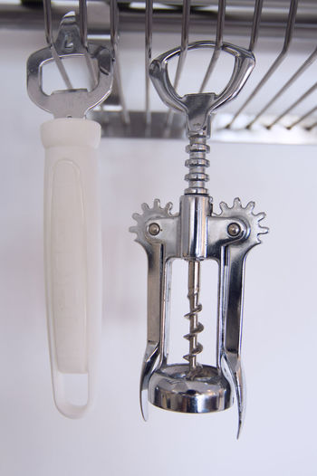 Close-up of corkscrew and opener in kitchen