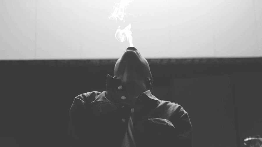 Man emitting smoke from mouth