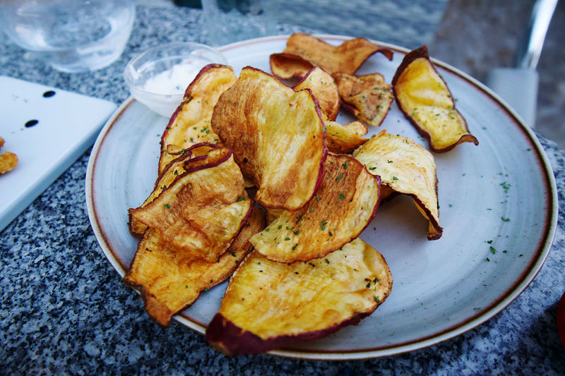 Selfmade potato chips on plate 