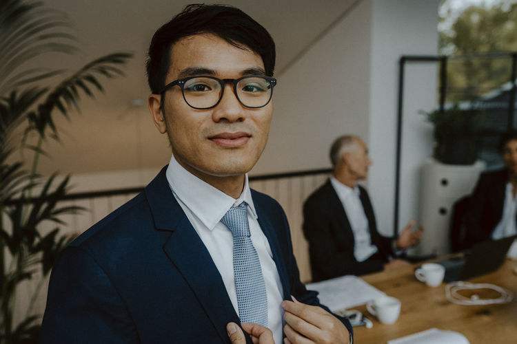 Portrait of male entrepreneur in board room at office