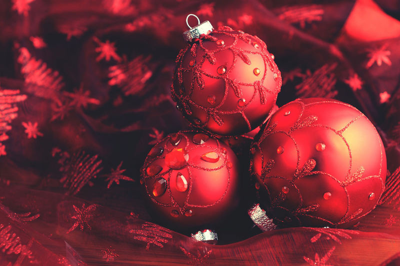 Close-up of red christmas baubles on table