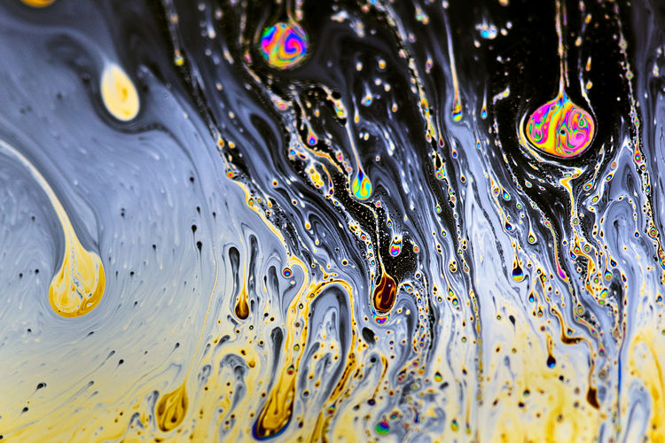 FULL FRAME SHOT OF WATER DROPS ON MULTI COLORED BUBBLES