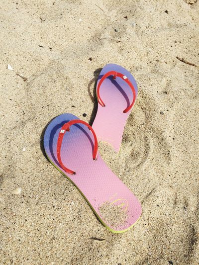 High angle view of pink slippers at beach