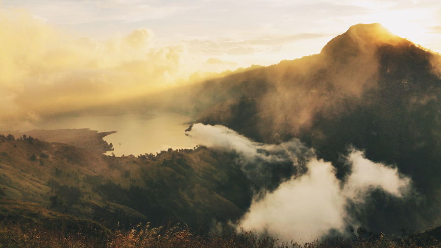 Scenic view of mount rinjani against sky during sunset