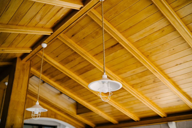 Low angle view of illuminated light hanging from ceiling