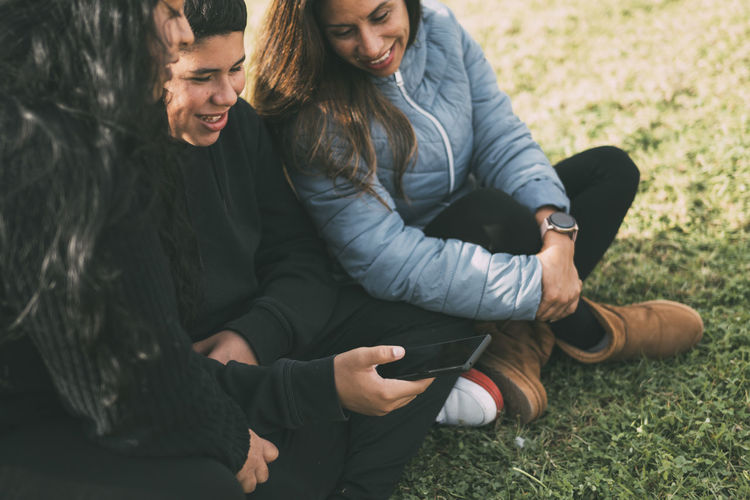 Low section of woman sitting on field