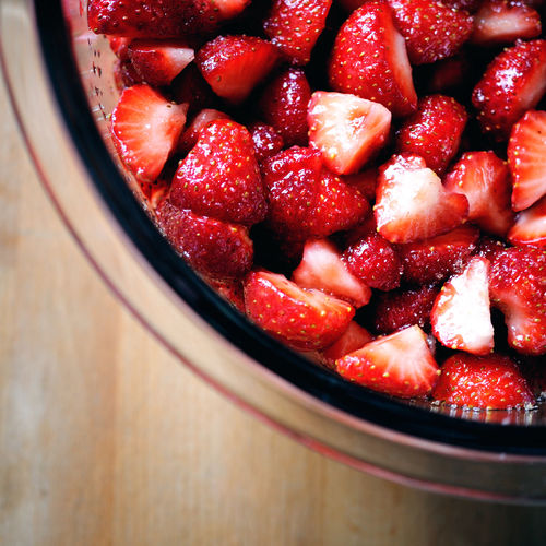 Directly above shot of chopped strawberries in bowl on table