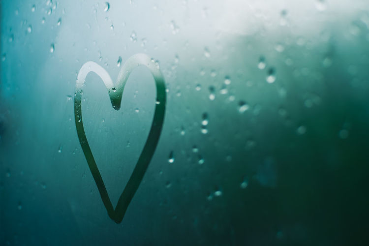 Close-up of wet heart shape on glass window