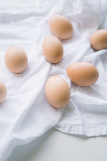 Brown eggs on a white kitchen towel