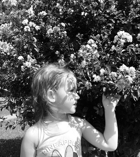 Little girl looking away in sunlight black and white 