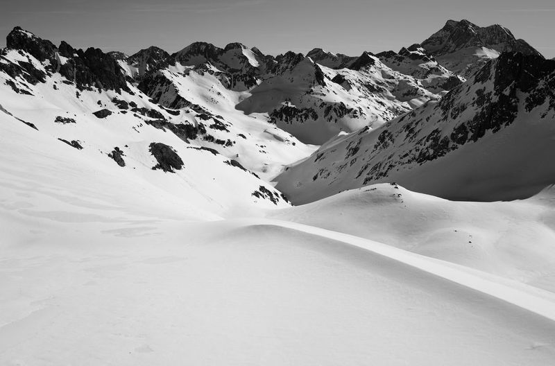 Scenic view of snow covered mountains against sky
