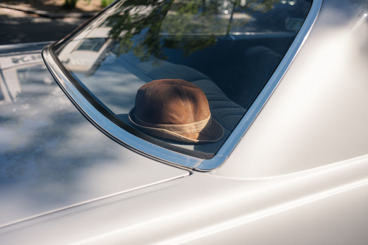 Old brown leather hat behind car window
