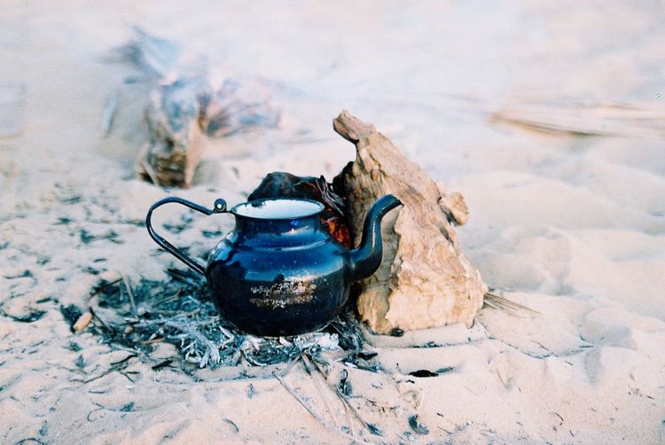 Teapot on campfire at beach